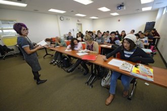 English teacher Michelle Gonzales, left, asks a question from student Virginia Gomes, 17, of Dublin, while enrolled in English 1A class at Las Positas College in Livermore, Calif., on Monday, Oct. 3, 2016. (Jose Carlos Fajardo/Bay Area News Group)