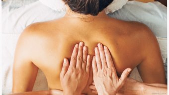woman gets back massage for emotional and physical tension